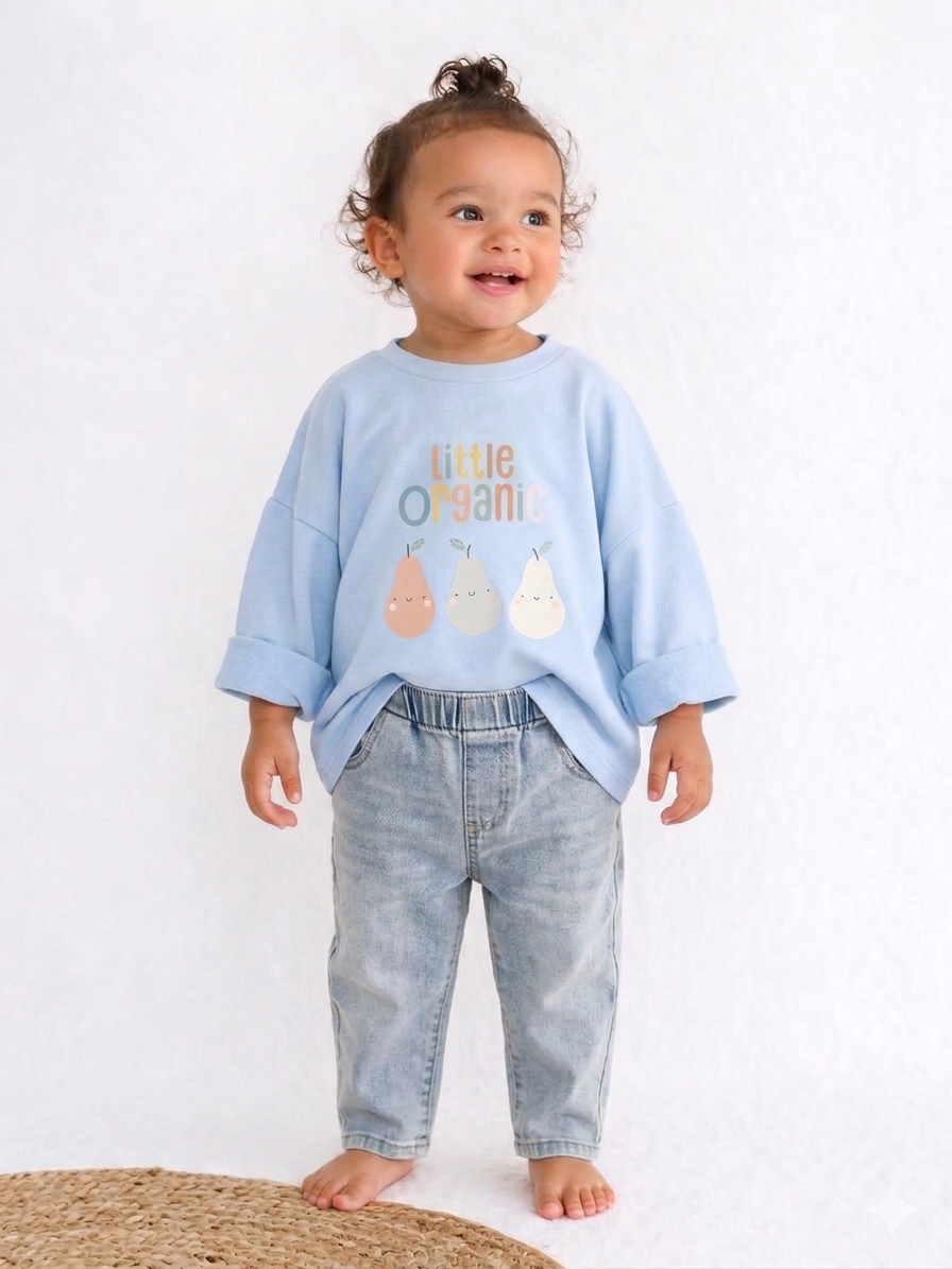 Child wearing a light blue shirt with text and graphics, standing on a white background